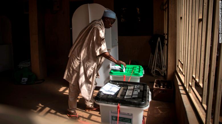 One of the first voters casts his ballots for presidential and parliamentary seats on Saturday, February 23, at the Unguwar Sarki polling station in Kaduna, Nigeria.