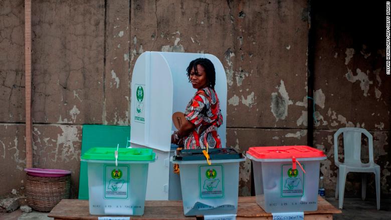 A woman glances over at the ballot boxes one last time before casting her vote on Saturday.