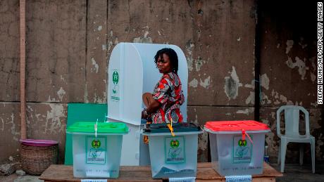 A woman glances over at the ballot boxes one last time before casting her vote at one of the polling unit in Lagos on February 23, 2019. - Nigerians began voting for a new president on February 23 after a week-long delay that has raised political tempers, sparked conspiracy claims and stoked fears of violence. Some 120,000 polling stations began opening from 0700 GMT, although there were indications of a delay in the delivery of some materials and deployment of staff, AFP reporters said. (Photo by STEFAN HEUNIS / AFP)        (Photo credit should read STEFAN HEUNIS/AFP/Getty Images)