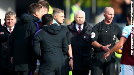 Tottenham manager Mauricio Pochettino (second from left) was upset with referee Mike Dean (second from right) after his team lost at Burnley. 