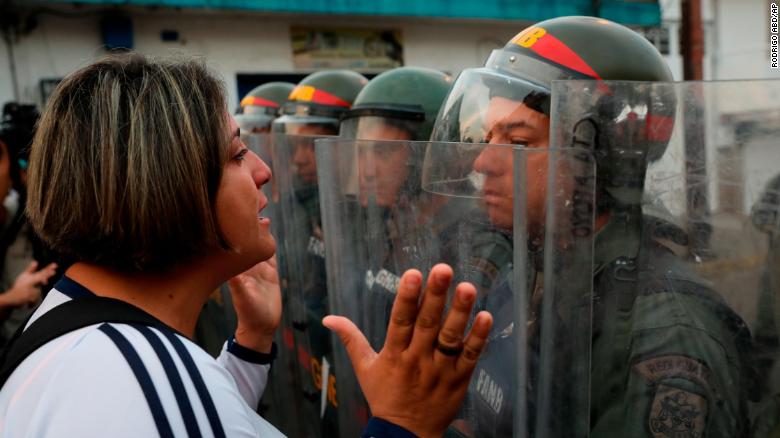 A demonstrator confronts a member of the Venezuelan National Guard on Saturday, February 23, in Urena, Venezuela, near the Colombian border.