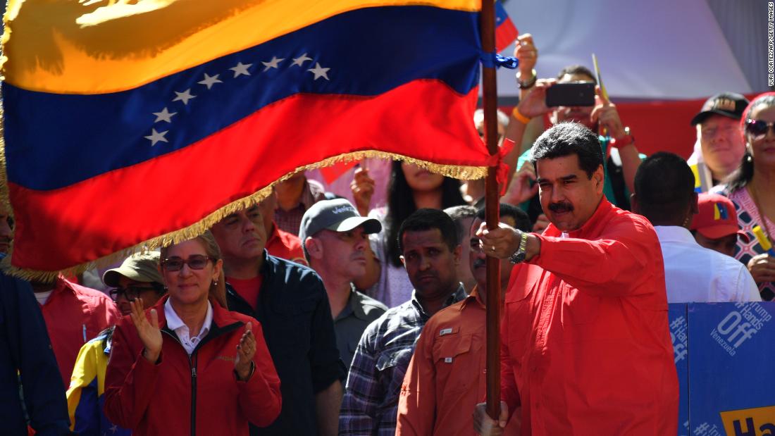 Maduro waves the national flag during a pro-government march in Caracas on February 23. During the rally at the Venezuelan capital, Maduro told supporters he is breaking all diplomatic relations with Colombia and is calling for its ambassadors and consuls to leave Venezuela. Maduro recently began a second term after a 2018 vote that his political opposition and many in the international community denounced as a sham.