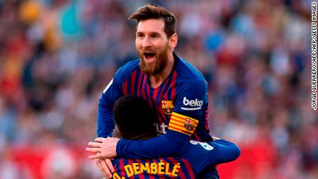 Lionel Messi celebrates with teammate Ousmane Dembele after scoring against Sevilla. 