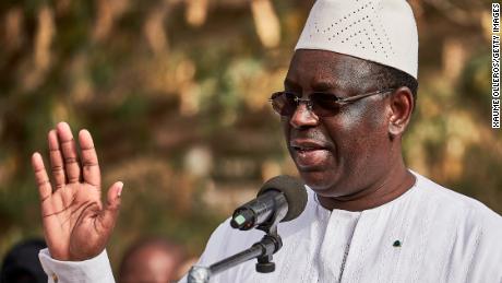 President Macky Sall greets the crowd after voting at a polling station on February 24 in Fatick, Senegal.