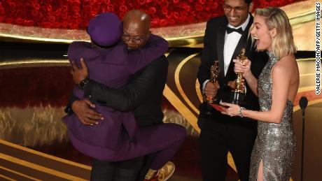 Spike Lee jumps in the arms of Actor Samuel L. Jackson as he accepts the award for best adapted screenplay 