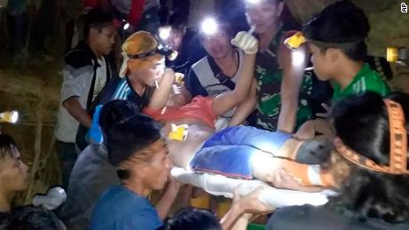 Indonesian Search And Rescue Agency (BASARNAS) rescuers evacuate a survivor from a collapsed gold mine in Bolaang Mongondow, North Sulawesi, Indonesia. 