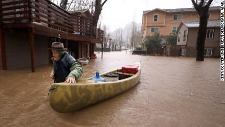 Jesse Hagan evacuates to higher ground Tuesday in Guerneville. 