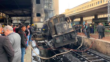 A destroyed train rests on tracks Wednesday after a fire at the main train station in Cairo.