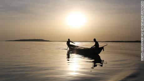 Fishermen heading off to collect their second catch of the day on Lake Volta.