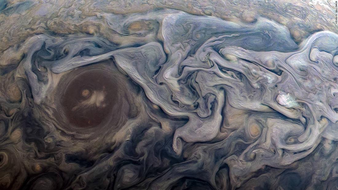 These dramatic swirls on Jupiter are atmospheric features. Clouds swirl around a circular feature in a jet stream region.
