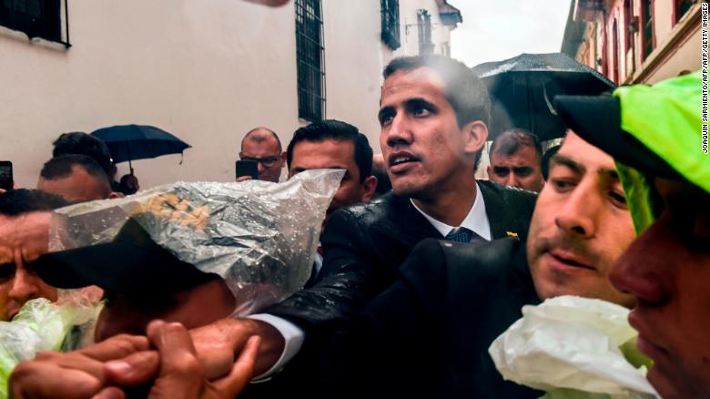 Venezualan opposition leader and self-declared acting president Juan Guaido (C) is greeted by people after holding a meeting with members of a multinational support group in the framework of the Lima Group to discuss a joint strategy to resolve Venezuela&#39;s crisis, at the Foreign Ministry in Bogota, on February 25, 2019. 