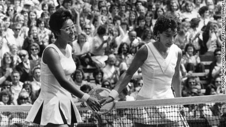 Heldman (right) meets Kazuko Sawamatsu at the net after facing the Japanese player at Wimbledon in 1974.