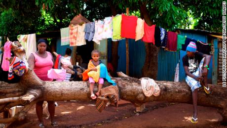 A Chagosian family in the slum of Baie du Tombeau, in Mauritius, with a Chagossian flag.