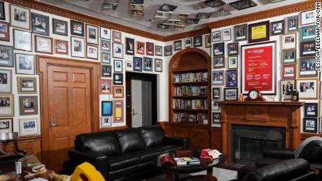 Novak's office walls and ceiling are lined with photos of him with former employees and their recognition awards. 