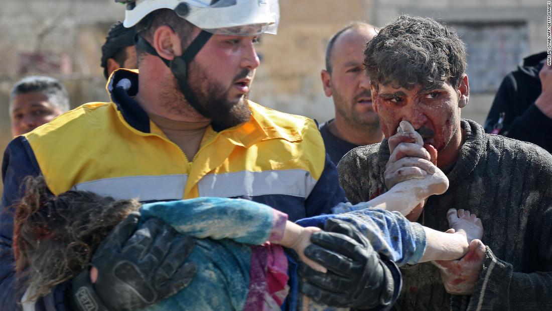 Abdul Razzak Qatran kisses the feet of his 3-year-old daughter, Elaf, who died in the airstrike.