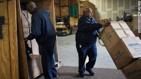 Jerome Davis, left, and Raleigh Head work in the warehouse of E.E. Ward. They have both worked at the company for more than 30 years. 