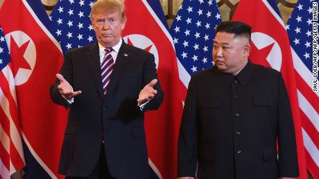 US President Donald Trump, left, and North Korea&#39;s leader Kim Jong Un arrive for a meeting at the Sofitel Legend Metropole hotel in Hanoi on February 27, 2019. 