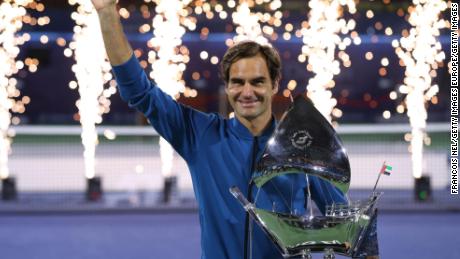 Roger Federer of Switzerland poses with the trophy after claiming his 100th career title in the Dubai. 