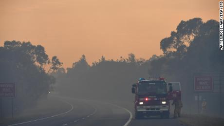 A Country Fire Authority (CFA) crew is seen on the Bunyip side of the Princes Highway on Sunday in the Australian state of Victoria. 