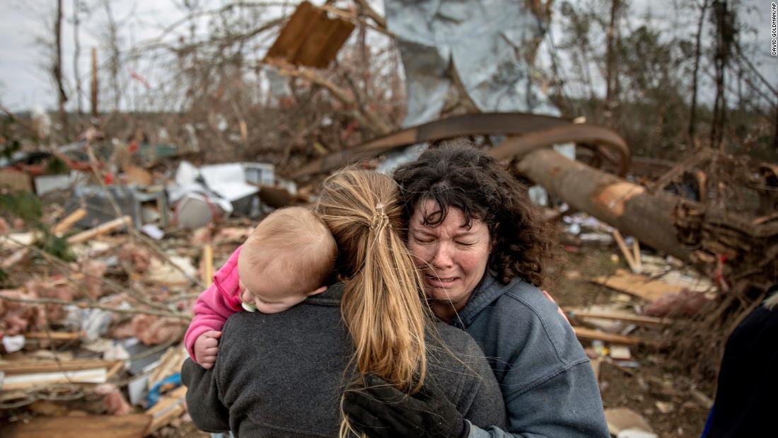 Carol Dean, right, cries while being embraced by Megan Anderson and her 18-month-old daughter, Madilyn, on Monday, March 4. Dean was going through the debris of the home she shared with her husband, David, who died in the tornado. &quot;He was one in a million,&quot; she said of her husband. &quot;He&#39;d send me flowers to work just to let me know he loved me. He&#39;d send me some of the biggest strawberries in the world. I&#39;m not going to be the same.&quot;