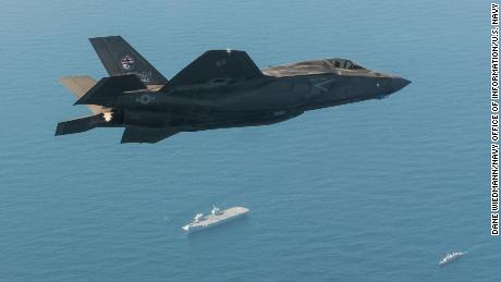 A US F-35B fighter jet flies over the Royal Navy aircraft carrier HMS Queen Elizabeth during 2018 exercises.