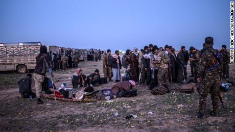 Suspected ISIS fighters who fled Baghouz await processing.