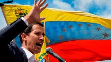 Venezuela&#39;s National Assembly head Juan Guaido speaks to the crowd during a mass opposition rally against leader Nicolas Maduro in which he declared himself the country&#39;s &quot;acting president&quot;, on the anniversary of a 1958 uprising that overthrew a military dictatorship, in Caracas on January 23, 2019. - &quot;I swear to formally assume the national executive powers as acting president of Venezuela to end the usurpation, (install) a transitional government and hold free elections,&quot; said Guaido as thousands of supporters cheered. Moments earlier, the loyalist-dominated Supreme Court ordered a criminal investigation of the opposition-controlled legislature. (Photo by Federico PARRA / AFP)        (Photo credit should read FEDERICO PARRA/AFP/Getty Images)