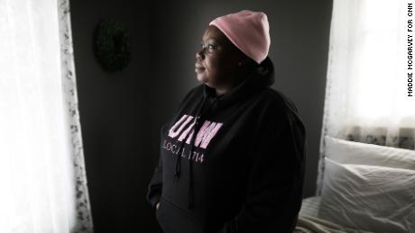 Felice Robinson stands in her home in Warren, Ohio, after getting off of the night shift at work at the Lordstown GM plant.