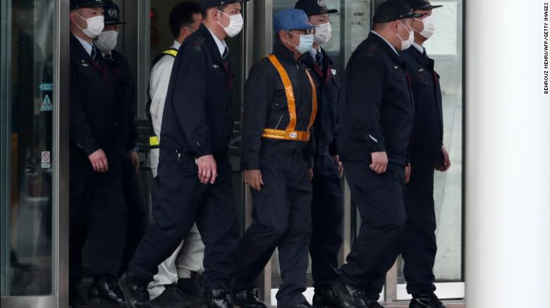 Former Nissan chairman Carlos Ghosn, wearing a  blue cap and a face mask, when he was released on bail.