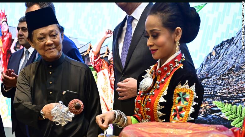 Malaysia's Minister for Tourism, Art and Culture Mohamaddin Ketapi attends a welcome ceremony at a booth promoting his country during the International Tourism Trade Fair (ITB) in Berlin.