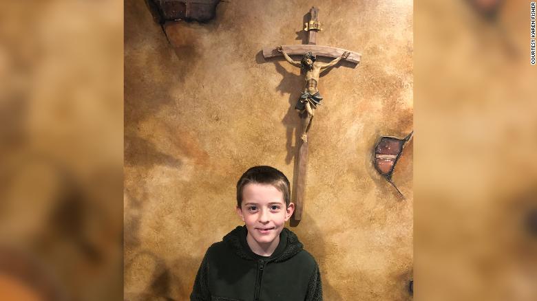 William McLeod stands in front of a crucifix in this picture taken by his grandmother, Karen Fisher.