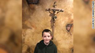 William McLeod stands in front of a crucifix in this picture taken by his grandmother, Karen Fisher.