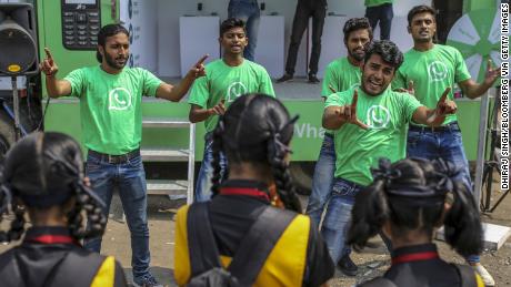 WhatsApp ambassadors perform a skit during a roadshow for the messaging service in Pune, India in October. Cheap phones and rock-bottom rates mean more Indians are using the app.