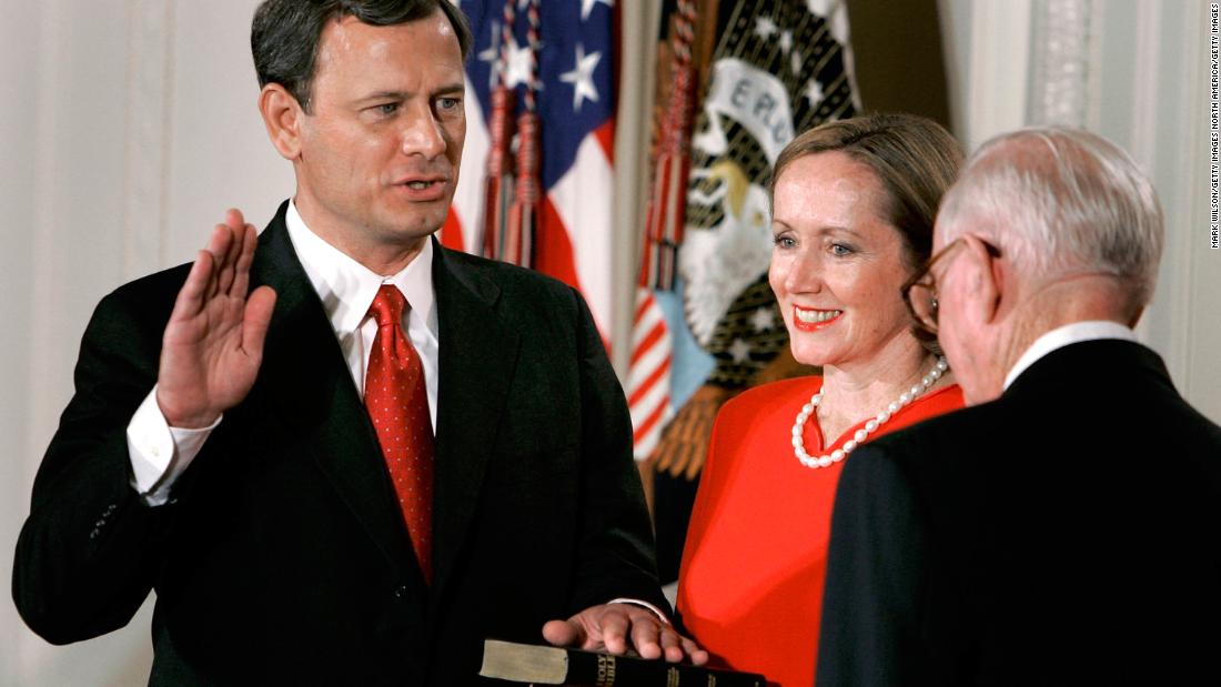 Roberts&#39; wife, Jane, holds a Bible as her husband is sworn in by Supreme Court Justice John Paul Stevens.