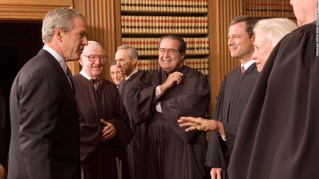 Bush enjoys a light moment with Roberts and other Supreme Court justices on Roberts&#39; first day. With Bush, from left, are John Paul Stevens, Ruth Bader Ginsburg, David Souter, Antonin Scalia, Roberts, O&#39;Connor and Kennedy.
