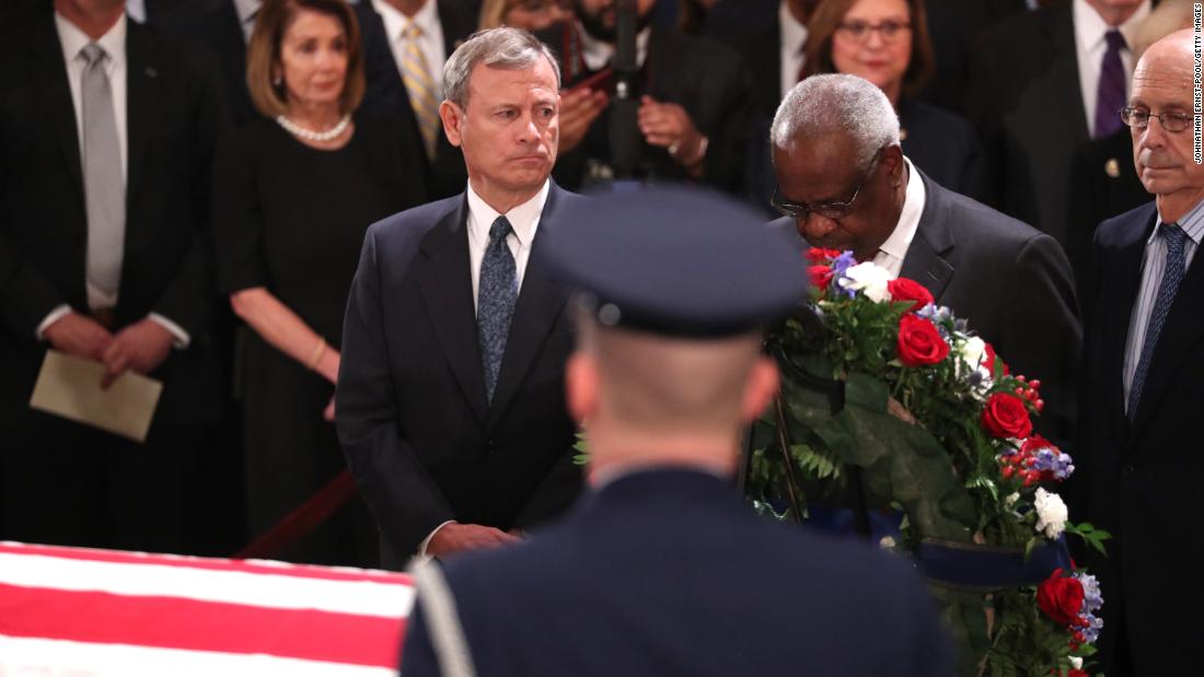 Roberts and Thomas pay their respects to the late President George H.W. Bush as he lies in state in December 2018.