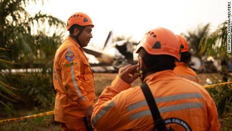 Members of the Colombian civil defense work where a plane crashed.