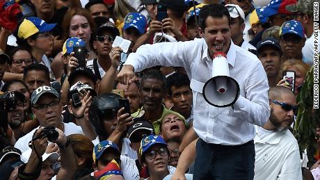 Guaido addresses supporters through a megaphone.