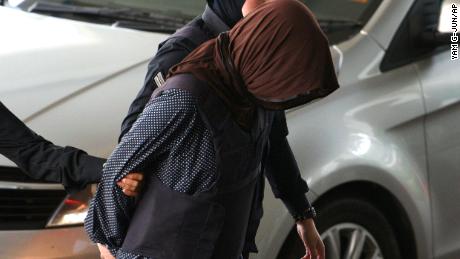 Vietnamese national Doan Thi Huong, foreground, is escorted by police as she arrives at Shah Alam High Court in Shah Alam, Malaysia, on Monday.