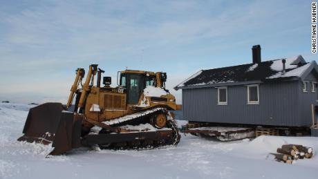 Christiane Hubner&#39;s hut is loaded onto the sled that will transport it to inland to a safe location.