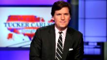In this March 2, 2017, file photo, Tucker Carlson, host of "Tucker Carlson Tonight," poses for photos in a Fox News Channel studio in New York. 