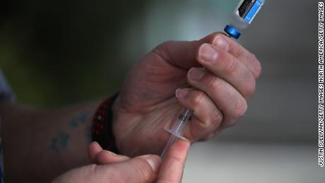 LOS GATOS, CA - JANUARY 25:  Veterinarian technician Justin Jones prepares a syringe with a canine influenza vaccine at Los Gatos Dog and Cat Hospital on January 25, 2018 in Los Gatos, California. Veternarians have seen a surge in dog owners seeking to have their dogs immunized for &quot;dog flu&quot; after reports that the highly contagious canine influenzaÑH3N2 and H3N8Ñis rapidly spreading.  (Photo by Justin Sullivan/Getty Images)