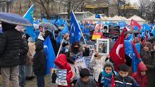 Demonstrators wave Uyghur nationalist flags in central Istanbul as they hold up photos of missing relatives caught up in China's crackdown on the Uyghur minority group.