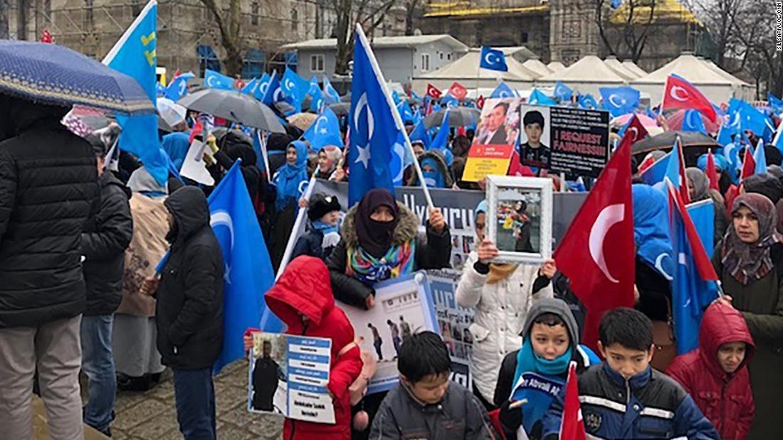 Demonstrators wave Uyghur nationalist flags in central Istanbul as they hold up photos of missing relatives caught up in China&#39;s crackdown on the Uyghur minority group.