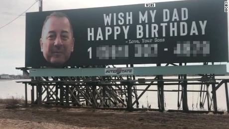 Sons prank dad with giant birthday billboard, bringing in thousands of phone calls.  CNN obscured the phone number on the billboard.