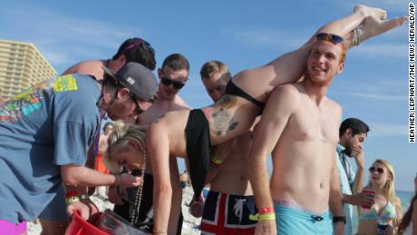 A woman drinks from a keg during spring break in March 2015 in Panama City Beach, Florida.