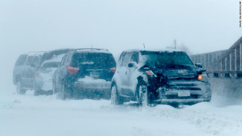 A string of wrecked vehicles sit on an overpass Wednesday over Interstate 70 in Aurora, Colorado.