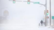 James Little crosses the street during a blizzard on Wednesday, March 13, 2019, in Cheyenne, Wyo.  Heavy snow hit Cheyenne about mid-morning Wednesday and was spreading into Colorado and Nebraska.  (Jacob Byk/The Wyoming Tribune Eagle via AP)