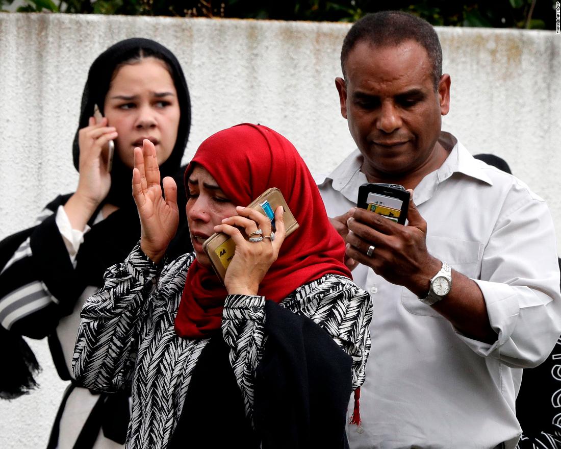 People talk on their phones after the attacks.
