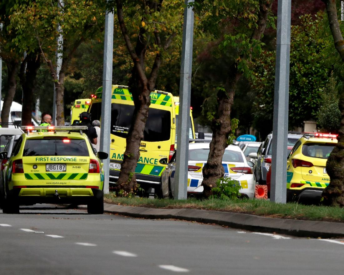 Ambulances and medical personnel stand by outside a mosque.